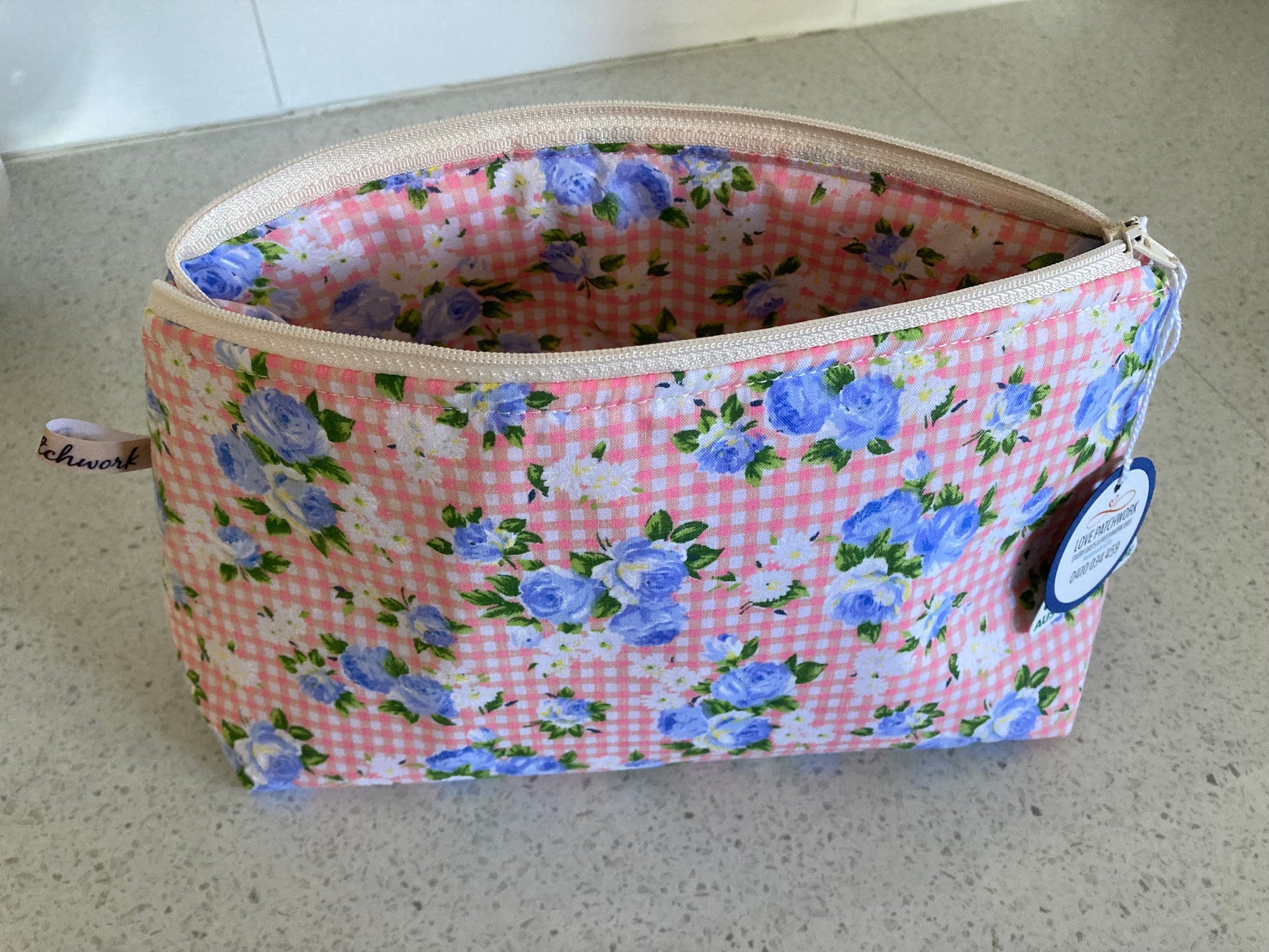 Floral-patterned fabric pouch on a neutral background