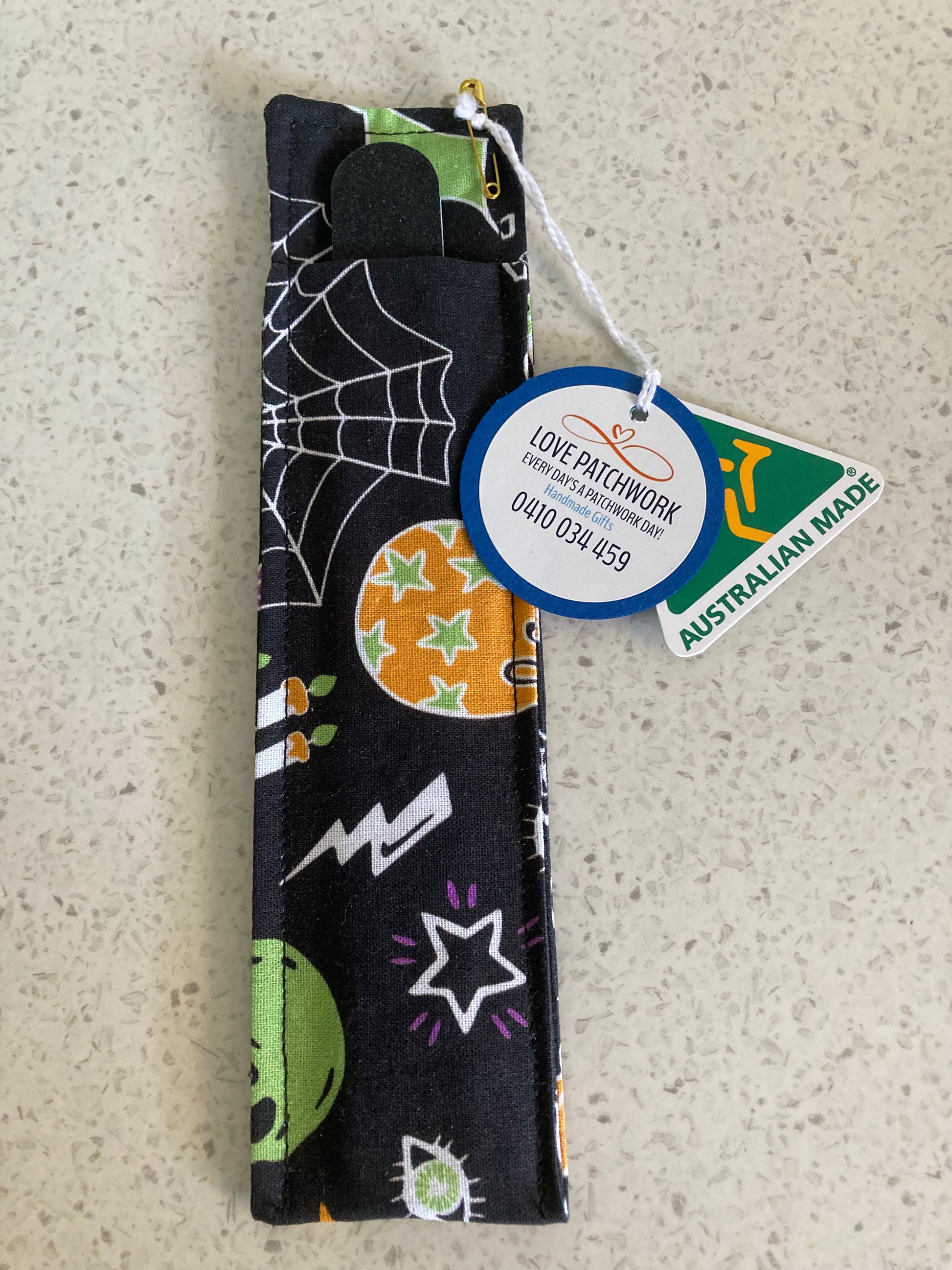 Nail file holder in Halloween-themed design cotton fabric on a textured surface with Love Patchwork & Australian Made tags