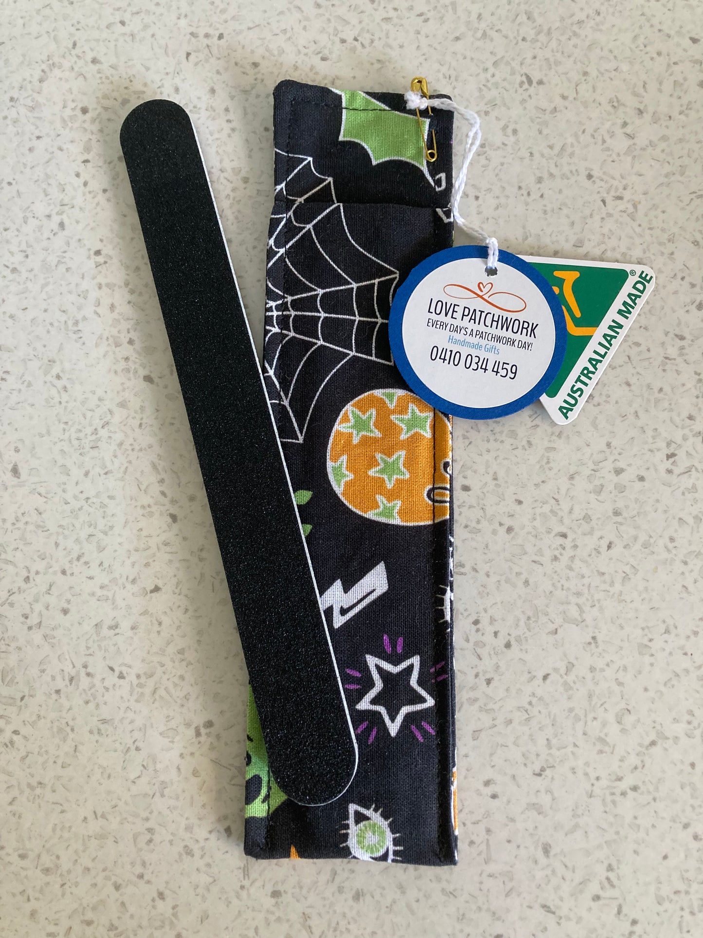 Nail file holder in Halloween-themed design cotton fabric on a textured surface with Love Patchwork & Australian Made tags