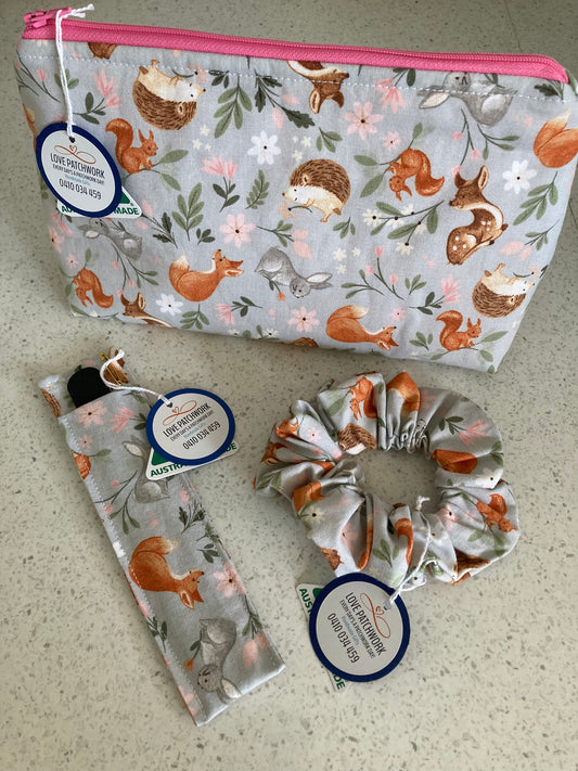 Woodland animals pattern gift set with pouch, scrunchie and nail file holder on neutral background