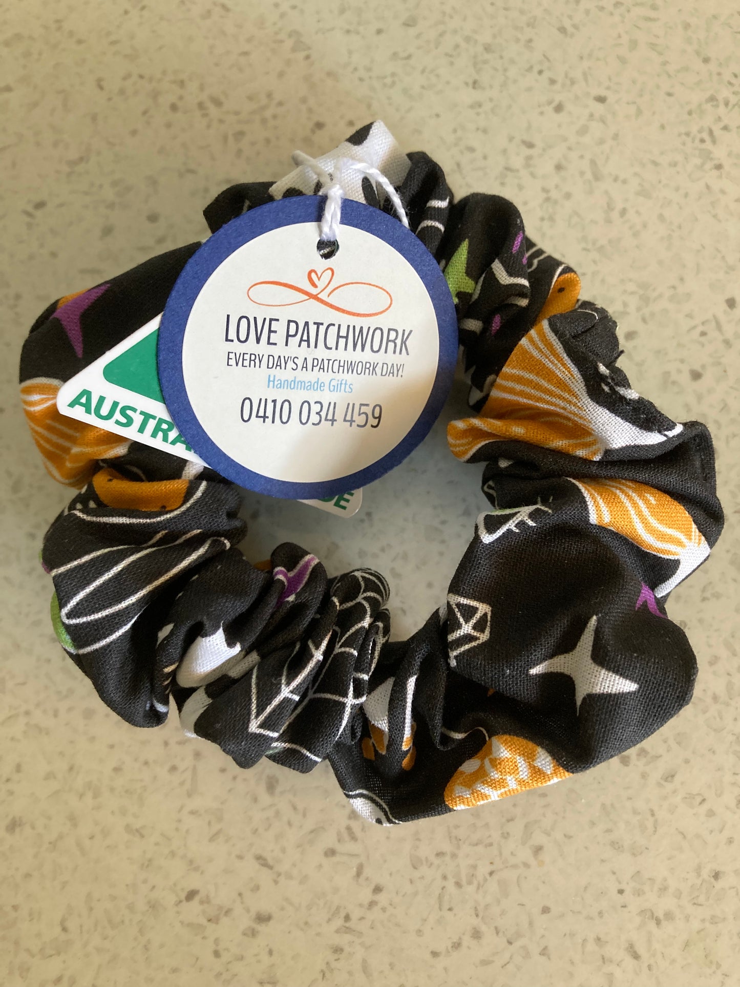 Halloween themed cotton fabric hair scrunchie with a visible Love Patchwork brand label. Australian Made