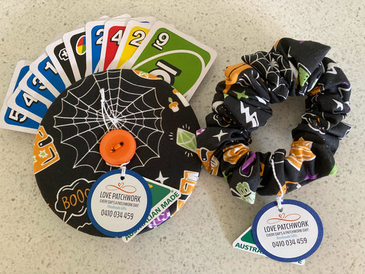 Set of Halloween-themed playing card holder and hair scrunchie with visible Love Patchwork branding 