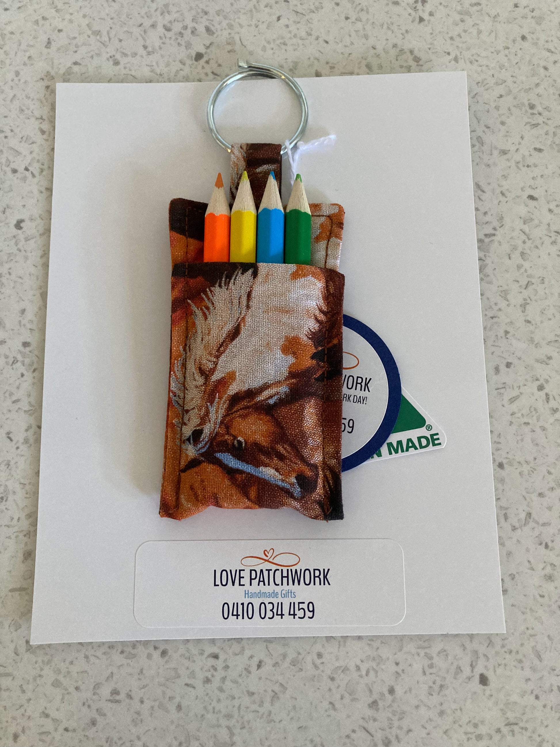 Keychain with coloured pencils in a equestrian themed holder on a white card with Love Patchwork branding. Australian Made