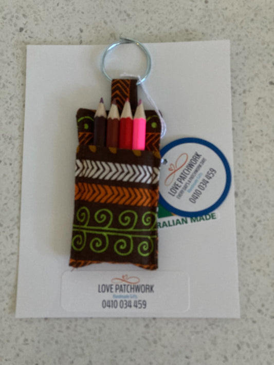 Indigenous inspired novelty keychain with colourful pencils on a card featuring 'Love Patchwork' branding. Australian Made