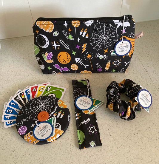 Halloween-themed gift set consisting of pouch, hair scrunchie, nail file holder and playing card holder on a light surface. Australian Made by Love Patchwork