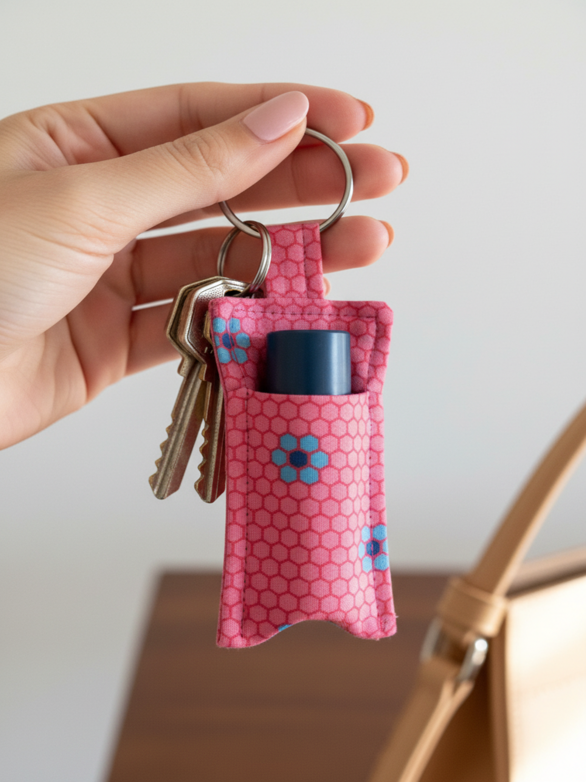 Pink keyring lip balm holder with keys attached